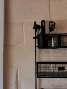 a black shelf with utensils on a wall at Crew 2 Savynomad Harbour Residences wow Views in Cospicua