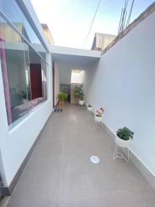 einen Balkon eines Gebäudes mit Stühlen und Pflanzen in der Unterkunft Apartamento/Departamento independiente nuevo in Tacna