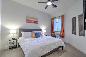 a bedroom with a large bed with a ceiling fan at Private Rooftop Terrance-Walk Score 81-Shopping District-King Bed-Parking 4020 in Scottsdale