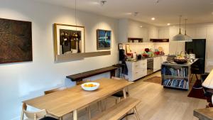 a kitchen with a table and a dining room at Stylish Townhouse in Auckland