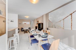 a dining room with a white table and chairs at 100m to a beach Spacious apartm in Playa de San Juan +15 photos