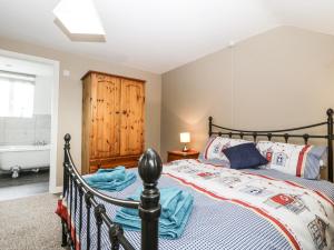 a bedroom with a bed and a bath tub at 8A Rosewood Avenue in Burnham on Sea