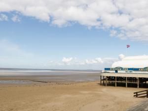 a view of a beach with a pier and the ocean at 8A Rosewood Avenue in Burnham on Sea