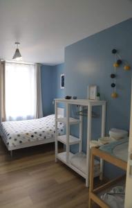 a childs bedroom with a bed and a window at Maison chaleureuse entre mer et campagne in Colombiers-sur-Seulles
