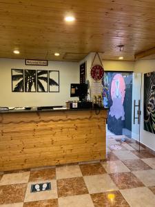 a bar in a restaurant with a wooden wall at Rafiki Hostel in Wadi Musa