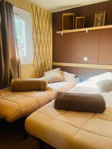 Zimmer mit 2 Betten und einem Fenster in der Unterkunft Mobil-home COSY clim&tv-3 Chambres in Vic-la-Gardiole