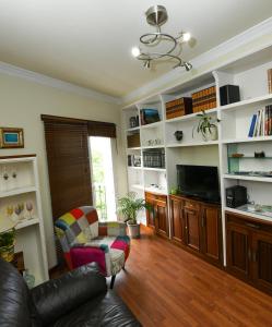 a living room with a couch and a tv at CASA VIVA in Santa Cruz de la Palma