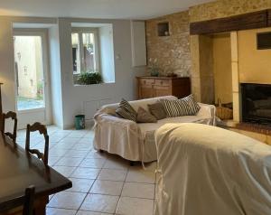 een woonkamer met een bank en een open haard bij Holidayhome for 6 persons at Ferme la Geneste in Coux-et-Bigaroque
