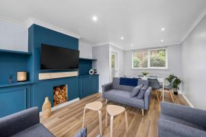 a living room with a blue wall at The School House in Broughty Ferry