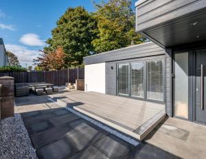 a backyard with a wooden deck next to a house at The School House in Broughty Ferry