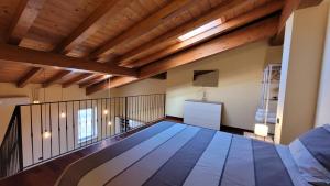 a room with a wooden floor and wooden beams at Borgo Antico Lake Endine Hospitality in Endine Gaiano