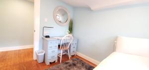 a bedroom with a white dresser and a mirror at The Beachy Bungalow w/King Bed, near Dtwn & Beach in St. Petersburg