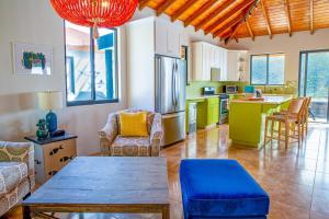 a kitchen with a table and chairs in a room at Jost Van Dyke, BVI 3 Bedroom Villa with Caribbean Views & Pool in Jost Van Dyke