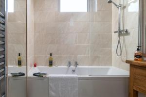 a bathroom with a tub and a shower with a sink at The Elderton, Newbiggin By The Sea, Northumberland in Newbiggin-by-the-Sea +29 photos