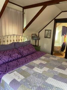 a purple bed in a room with a attic at Downtown B&B with Jacuzzi in Glenwood Springs