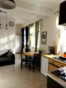 a kitchen and living room with a table and chairs at Apartament Kętrzyński in Kętrzyn