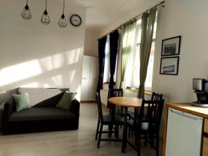 a living room with a couch and a table at Apartament Kętrzyński in Kętrzyn