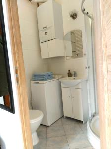 a bathroom with a toilet and a sink at Apartament Kętrzyński in Kętrzyn +19 photos