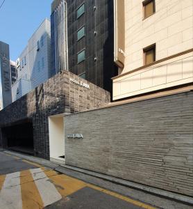 a brick wall next to a building at Lava Hotel in Seoul