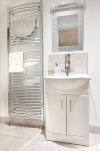 a bathroom with a sink and a mirror at Sperrin View Suite - Luxury space with Budget Friendly pricing in Maghera