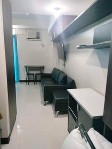 a living room with a couch and a table at Cubao Manhattanheights U31N TB, Studio Unit in Manila