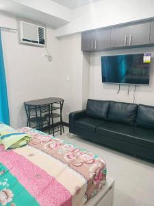 a living room with a couch and a table at Cubao Manhattanheights U31N TB, Studio Unit in Manila