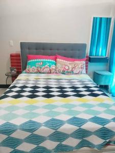 a bedroom with a bed with a black and white checkered floor at Cubao Manhattanheights U31N TB, Studio Unit in Manila