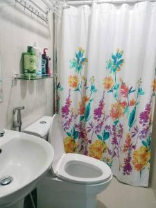 a bathroom with a toilet and a shower curtain at Cubao Manhattanheights U31N TB, Studio Unit in Manila