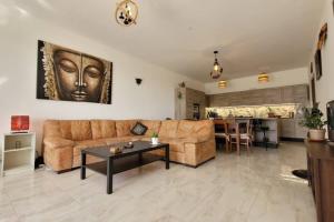 a living room with a couch and a table at Luxury en-suite Double. Beach-house with Sea Views in Mellieħa