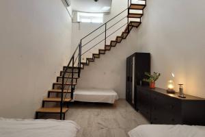 a room with a staircase with a mattress and a bed at Luxury en-suite Double. Beach-house with Sea Views in Mellieħa