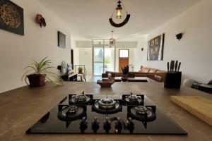 a living room with a table on the floor at Luxury en-suite Double. Beach-house with Sea Views in Mellieħa