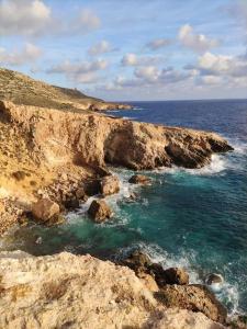 a view of a rocky shore with the ocean at Luxury en-suite Double. Beach-house with Sea Views in Mellieħa