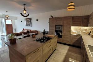a kitchen with a large island with a stove at Luxury en-suite Double. Beach-house with Sea Views in Mellieħa
