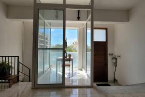 eine Glastür in einem Zimmer mit einem Tisch in der Unterkunft Luxury en-suite Double. Beach-house with Sea Views in Mellieħa