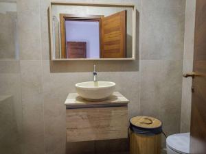 a bathroom with a sink and a mirror at Luxury en-suite Double. Beach-house with Sea Views in Mellieħa