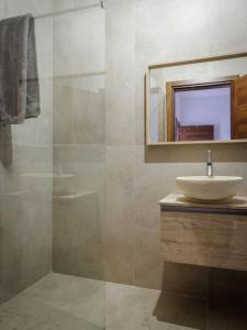a bathroom with a sink and a mirror at Luxury en-suite Double. Beach-house with Sea Views in Mellieħa