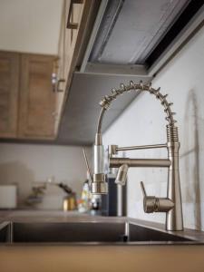 a sink in a kitchen with a faucet at Luxury en-suite Double. Beach-house with Sea Views in Mellieħa