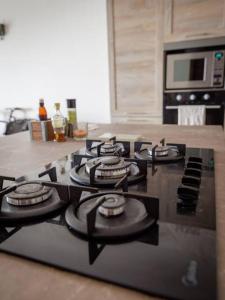 a black stove top oven in a kitchen at Luxury en-suite Double. Beach-house with Sea Views in Mellieħa