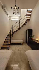 a room with a staircase and a room with two beds at Luxury en-suite Double. Beach-house with Sea Views in Mellieħa