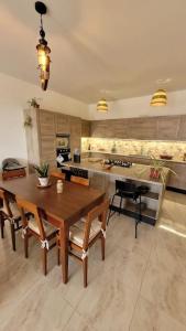 a large kitchen with a wooden table and chairs at Luxury en-suite Double. Beach-house with Sea Views in Mellieħa