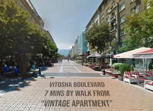 an empty street in a city with a sign on it at Vintage Top Centre Apartment in Sofia