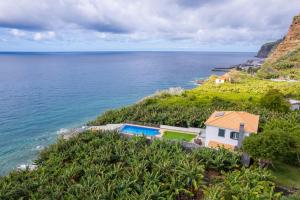 an aerial view of a house and the ocean at Infinite Ocean View Villa 20m above Ocean & Beach in Arco da Calheta