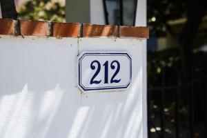 a sign on the side of a white house at Enzo’s House in Lucca