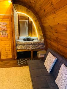 a small room with a bed in a wooden cabin at Gallas Pod House in Vouzela