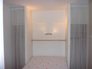 a small bedroom with a bed and a window at Tour Eiffel Beaugrenelle in Paris