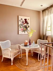 a room with a table and chairs and a painting at Guest House in Luxembourg