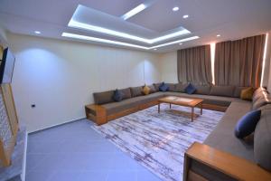 a living room with a couch and a table at RESIDENCE CENTROSUIT in Laayoune