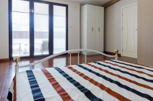 a bedroom with a bed with an american flag blanket at Modern Penthouse Apartment in Bitola in Bitola