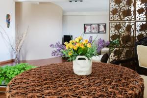 a vase of flowers sitting on top of a table at Modern Penthouse Apartment in Bitola in Bitola