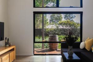 a living room with a door to a patio at The Dairy . Margaret River in Margaret River Town